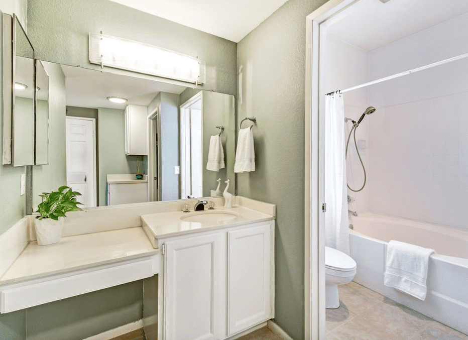Staging Tip:  White cabinets freshened up this older bathroom, while the white towels and shower curtain gave it a spa like feel.