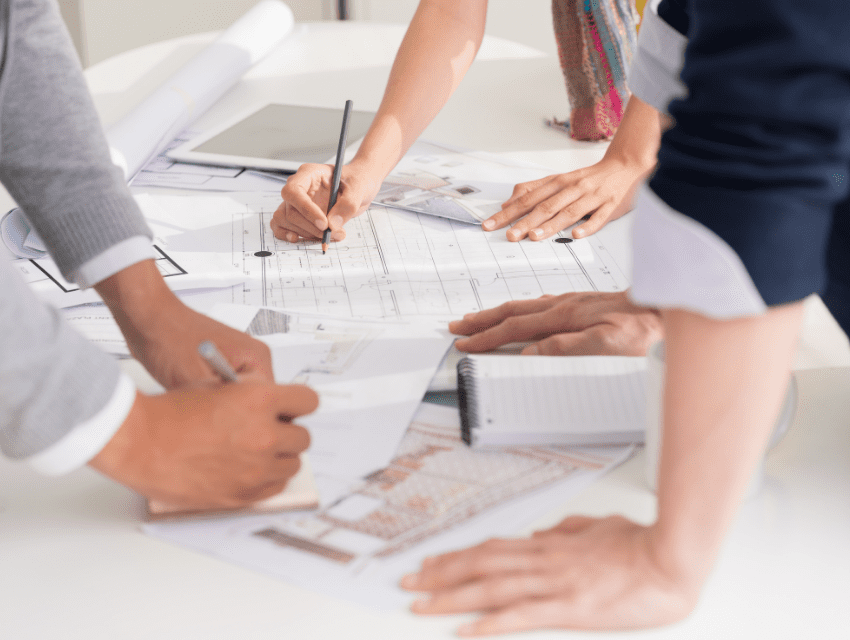 pamela sandall design _ los angeles california _ design team and contractor looking at home plans and making edits with pens _ how to determine an accurate timeline for your project