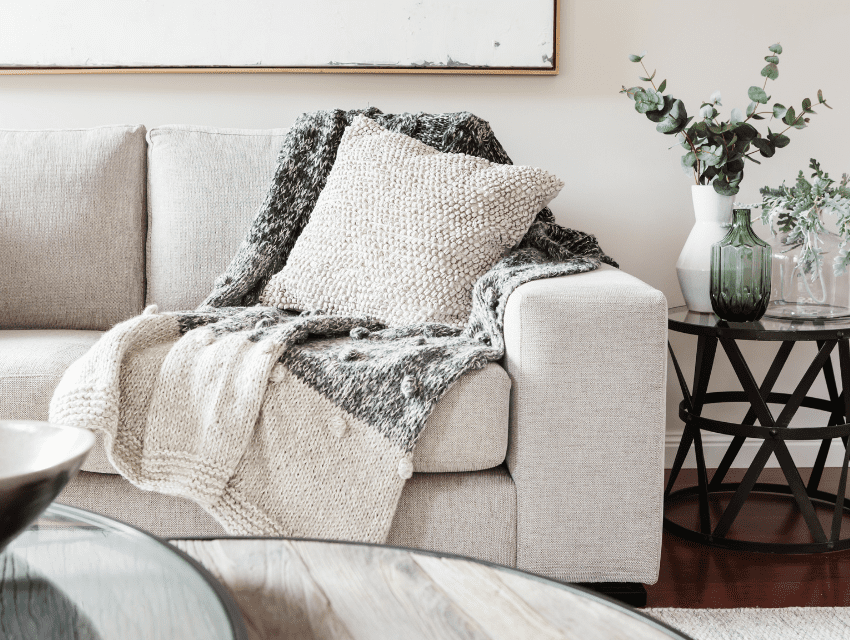 pamela sandall design _ los angeles california _ light sofa with throw pillow and blanket in living room with greenery and coffee table _ how to determine design project timelines