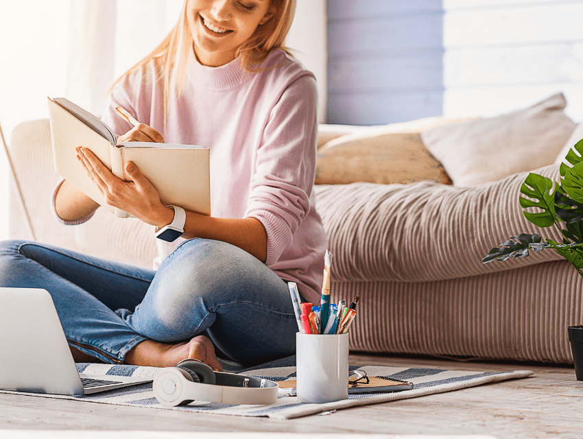 Pamela-Sandall-Design_Los-Angeles-California_How-to-Inspire-Feelings-of-Joy-at-Home_Woman-Sitting-on-Living-Room-Floor-with-Book-and-Paintbrushes